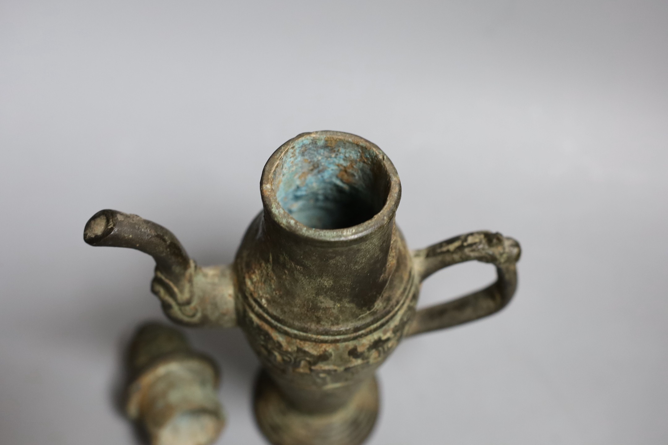 A Chinese archaistic bronze pouring vessel and cover, 17th/18th century, 22cms high